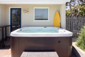 a jacuzzi tub in the backyard of a house at Bella Luna in Carpinteria