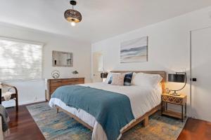 a bedroom with a large bed and a tv at Bella Luna in Carpinteria