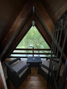 a attic room with two beds and a table at Ovčar Banja in Čačak
