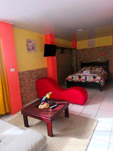 a room with a bed and a chair and a table at Kenai Mountain View in Concepción