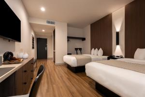a hotel room with two beds and a sink at Kins Hotel in Los Angeles +74 photos