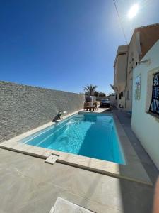 a swimming pool in front of a building at Dar Souleyman in Midoun