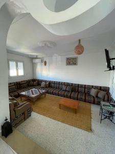 a living room with couches and a table at Dar Souleyman in Midoun