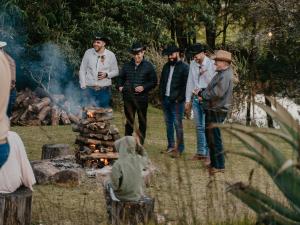 a group of men standing around a fire at Mount Park Guest Farm in Dargle +7 photos
