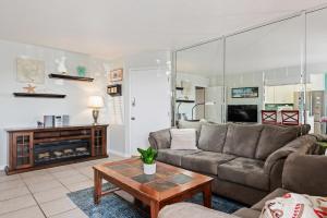 a living room with a couch and a fireplace at Carpinteria Shores CS 103 in Carpinteria +13 photos