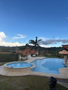 a large swimming pool in a yard at Finca La Yeye in Puentetierra