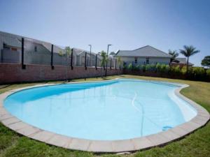 a large blue swimming pool in a yard at SafeHaven 45 in George