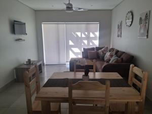 a living room with a table and a couch at SafeHaven 45 in George