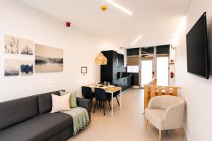 a living room with a couch and a table at SociaLodge - Piornais in Funchal