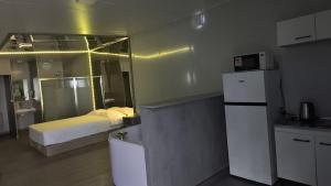 a kitchen with a bed and a refrigerator in a room at Apartamento 201 in Colonia Valdense +7 photos