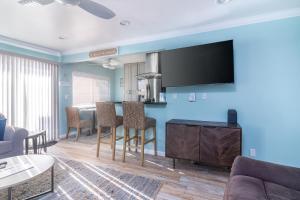 a living room with a table and a tv on a wall at Carpinteria Shores CS 110 in Carpinteria