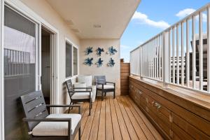 a balcony with chairs and a table on it at Carpinteria Shores CS 107 in Carpinteria +8 photos