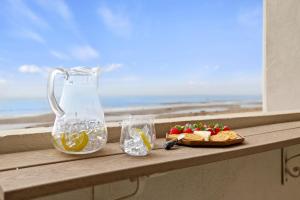 a table with a pitcher and a plate of fruit and a drink at Carpinteria Shores CS 209 in Carpinteria