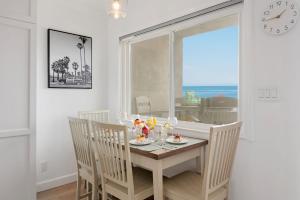 a dining room with a table and chairs and a window at Carpinteria Shores CS 209 in Carpinteria +20 photos