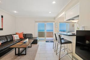 a living room with a couch and a table at Carpinteria Shores CS 212 in Carpinteria +20 photos