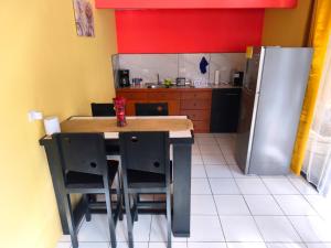 a kitchen with a table and a refrigerator at Kenai Mountain View in Concepción
