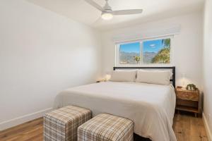 a white bedroom with a bed and a window at Carpinteria Shores CS 210 in Carpinteria