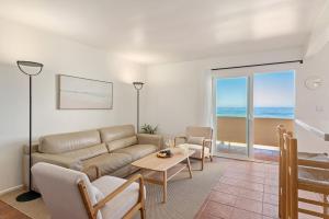 a living room with a couch and a table at Carpinteria Shores CS 210 in Carpinteria +19 photos