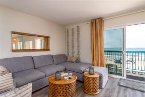 a living room with a couch and a large window at Carpinteria Shores CS 312 in Carpinteria