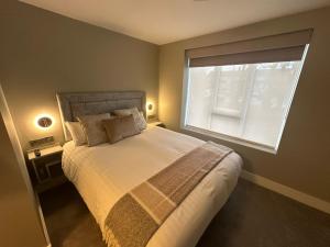 a bedroom with a large bed and a window at The Sliding Rock Inn in Galway