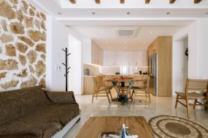 a living room with a couch and a table at Naxos Royal Villas in Stelida