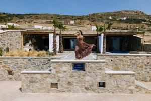a statue of a woman standing on top of a building at Naxos Royal Villas in Stelida
