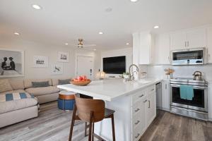 a kitchen and living room with white cabinets and a couch at Carpinteria Shores CS 109 in Carpinteria