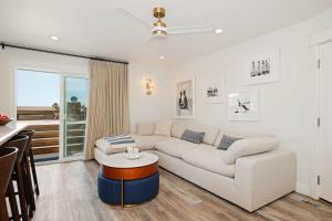a living room with a white couch and a table at Carpinteria Shores CS 109 in Carpinteria