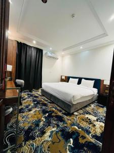 a hotel room with a bed and a carpet at Al Muhajir Serviced Apartments Quraish Branch in Jeddah +76 photos