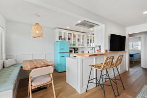 a kitchen with white cabinets and a blue refrigerator at Carpinteria Shores CS 206 in Carpinteria +9 photos