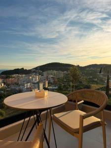 a table and chairs on a balcony with a view at Soléa Himara Guesthouse in Himare