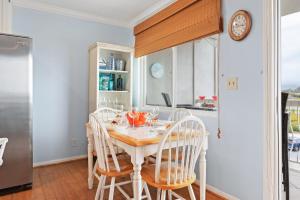 a kitchen with a table with chairs and a clock at Carpinteria Shores CS 302 in Carpinteria