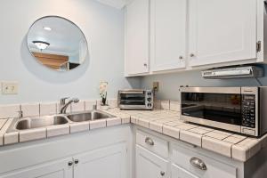 a kitchen with a sink and a microwave at Carpinteria Shores CS 302 in Carpinteria