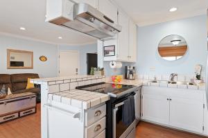 a kitchen with white cabinets and a counter top at Carpinteria Shores CS 302 in Carpinteria