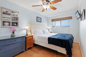 a bedroom with a bed and a ceiling fan at Carpinteria Shores CS 302 in Carpinteria +24 photos