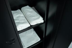 a shelf with white towels in a refrigerator at SociaLodge - Piornais in Funchal