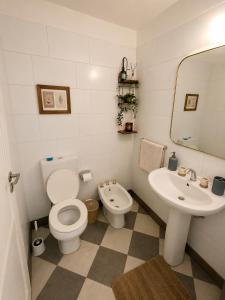 a bathroom with a toilet and a sink at Despertá frente al mar! Loft con bajada privada! in Santa Clara del Mar +8 photos