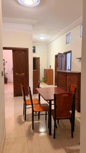 a dining room with a wooden table and chairs at Adelhouse in Saint-Louis