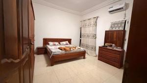 a bedroom with a bed and a dresser in it at Adelhouse in Saint-Louis