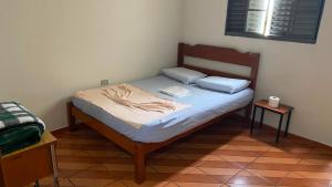 a small bedroom with a bed in a room at Hotel Gênio in Pouso Alegre +2 photos