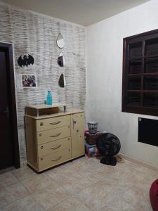 a room with a dresser in a room at Suíte em casa particular in Lagoa Santa