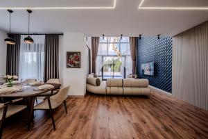 a living room with a table and a couch at Luxury Forest Villas with Private Pool in Antalya