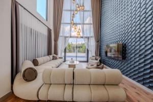 a large living room with couches and a tv at Luxury Forest Villas with Private Pool in Antalya