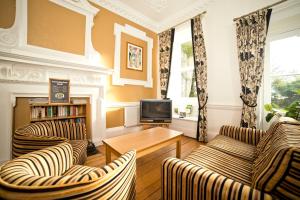a living room filled with furniture and a tv at YHA Penzance in Penzance
