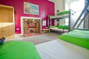 a bedroom with a fireplace and a bunk bed at YHA Penzance in Penzance