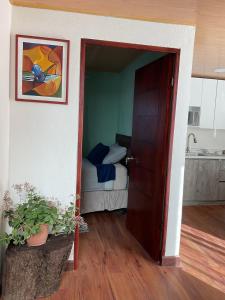 an open door to a bedroom with a bed at Cabaña, fogata, terraza in Santiago Sacatepéquez +63 photos