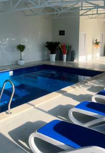 a large swimming pool with blue and white tiles at Rancho on Sevan beach by HV in Sevan