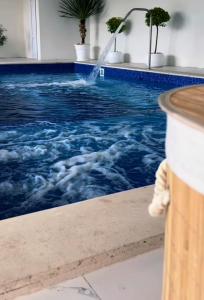 a swimming pool with a water fountain at Rancho on Sevan beach by HV in Sevan