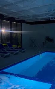 a swimming pool with blue lighting in a building at Rancho on Sevan beach by HV in Sevan