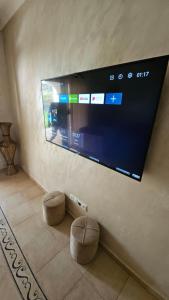 a flat screen tv hanging on a wall at Villa lux AP2 in Saïdia